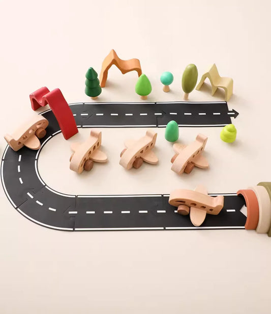 Wooden toy road with cars and trees on a light beige background