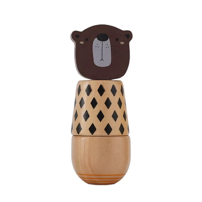 Wooden toy with bear face on top and geometric patterned body on a white background
