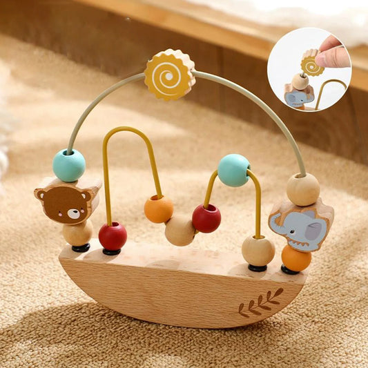 Wooden baby toy with colorful beads and animal figures on a wooden surface
