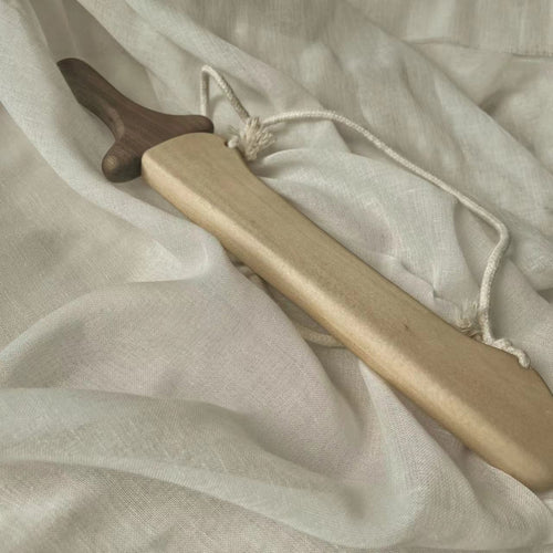 Handcrafted wooden toy sword with natural finish and rope, sustainable Montessori play