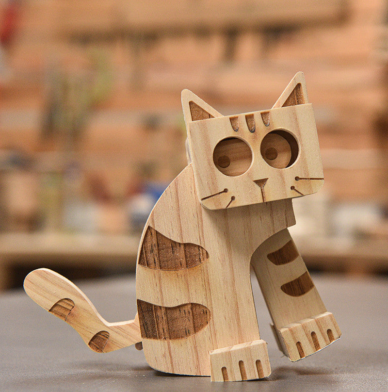 Wooden cat figurine on a blurred background