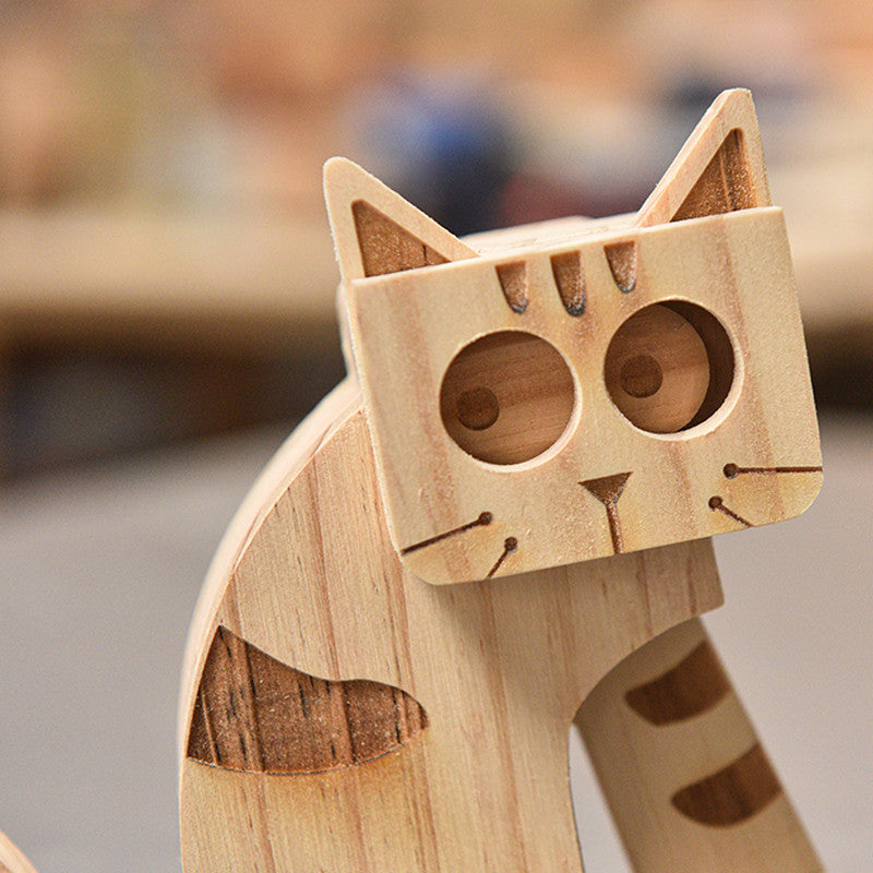 Wooden cat-shaped object with a blurred background