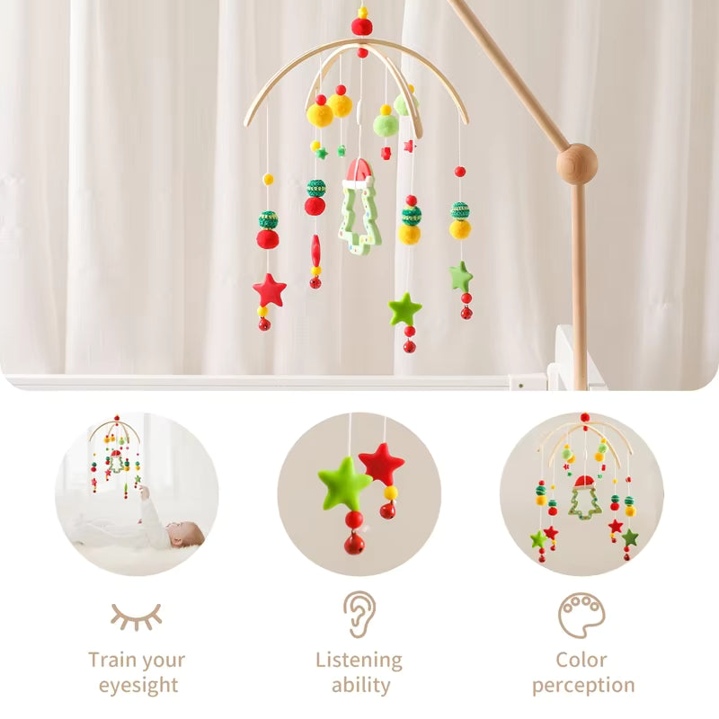 Colorful baby mobile with stars and balls on a stand against a white curtain.