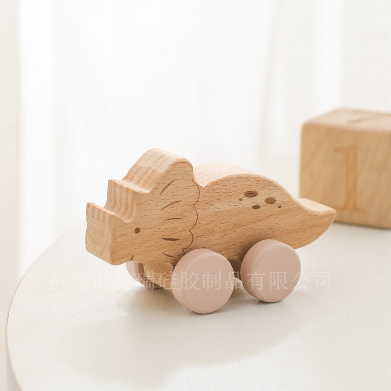 Wooden toy rhino on wheels with a soft focus background