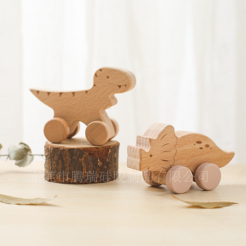 Two wooden animal toys on a light surface with a soft, neutral background