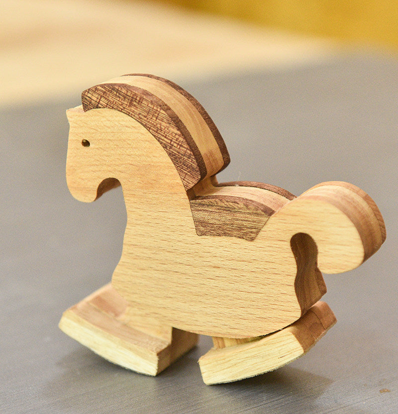 Wooden rocking horse toy on a neutral background