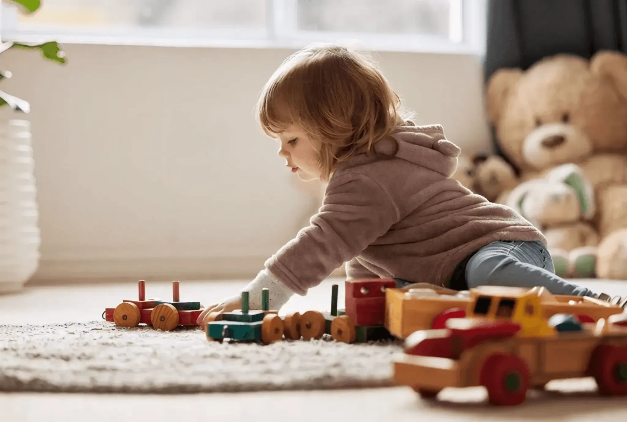 A lovely little girl playing among different wooden toys