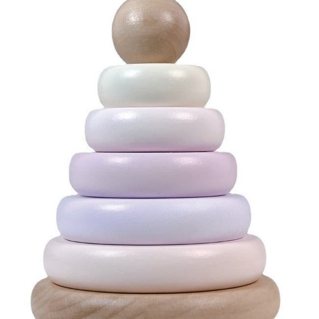Stack of wooden rings in pastel colors on a white background