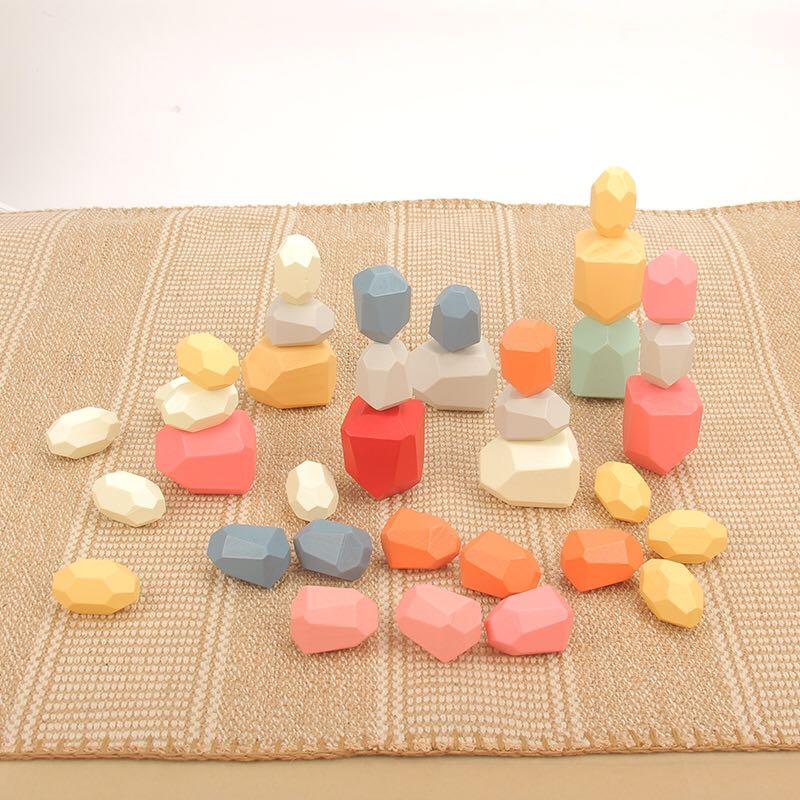 Colorful geometric stone toys on a textured surface