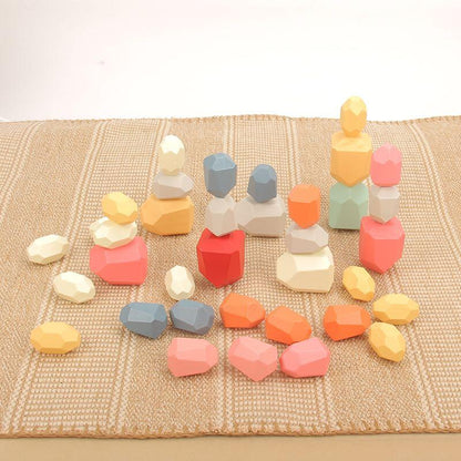 Colorful geometric stone toys on a textured surface