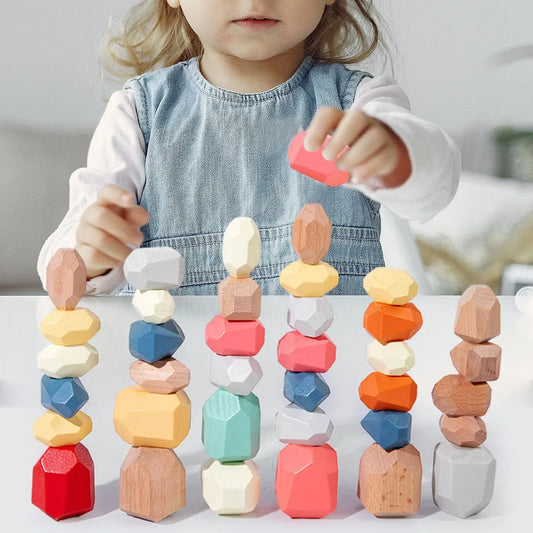 Child playing with colorful wooden building blocks on a table.