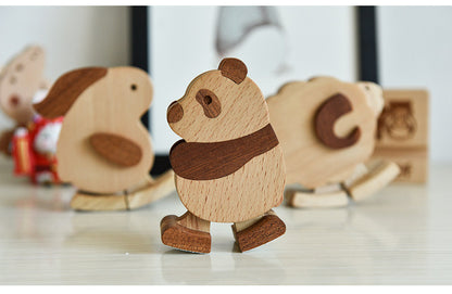 Wooden animal figurines on a reflective surface with a blurred background