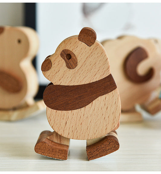 Wooden panda figurine with a scarf on a light surface