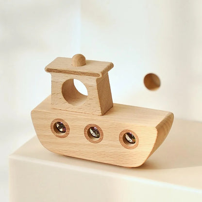 Wooden toy boat on a light beige background