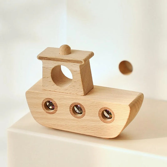 Wooden toy boat on a light beige background