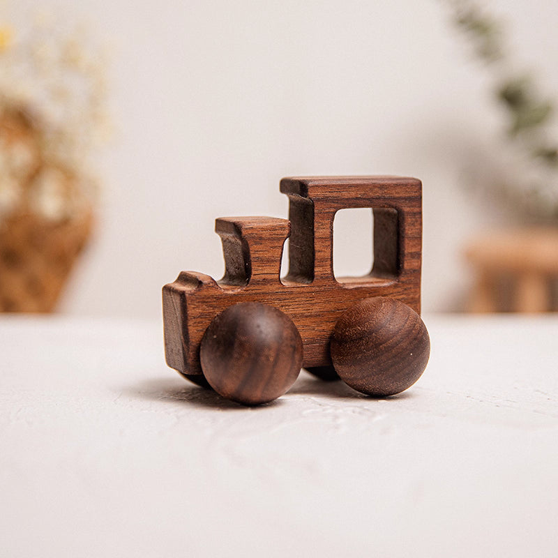 Wooden toy train on a light surface with a blurred background