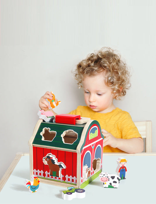 Child playing with a wooden farm toy set on a light gray background