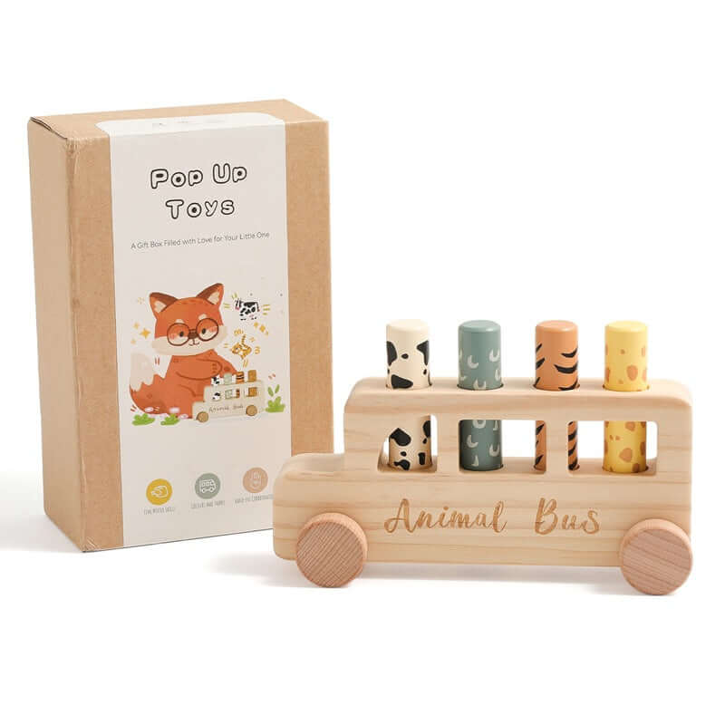 Wooden toy bus with animal figures and packaging on a white background