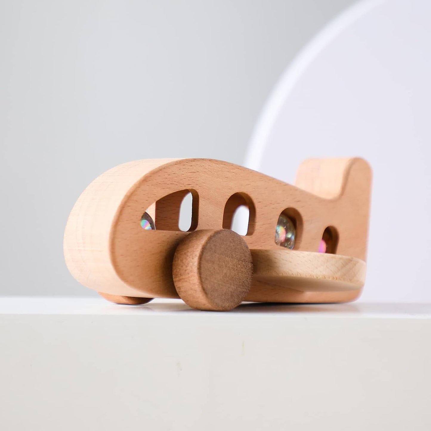 Wooden toy car on a light gray background