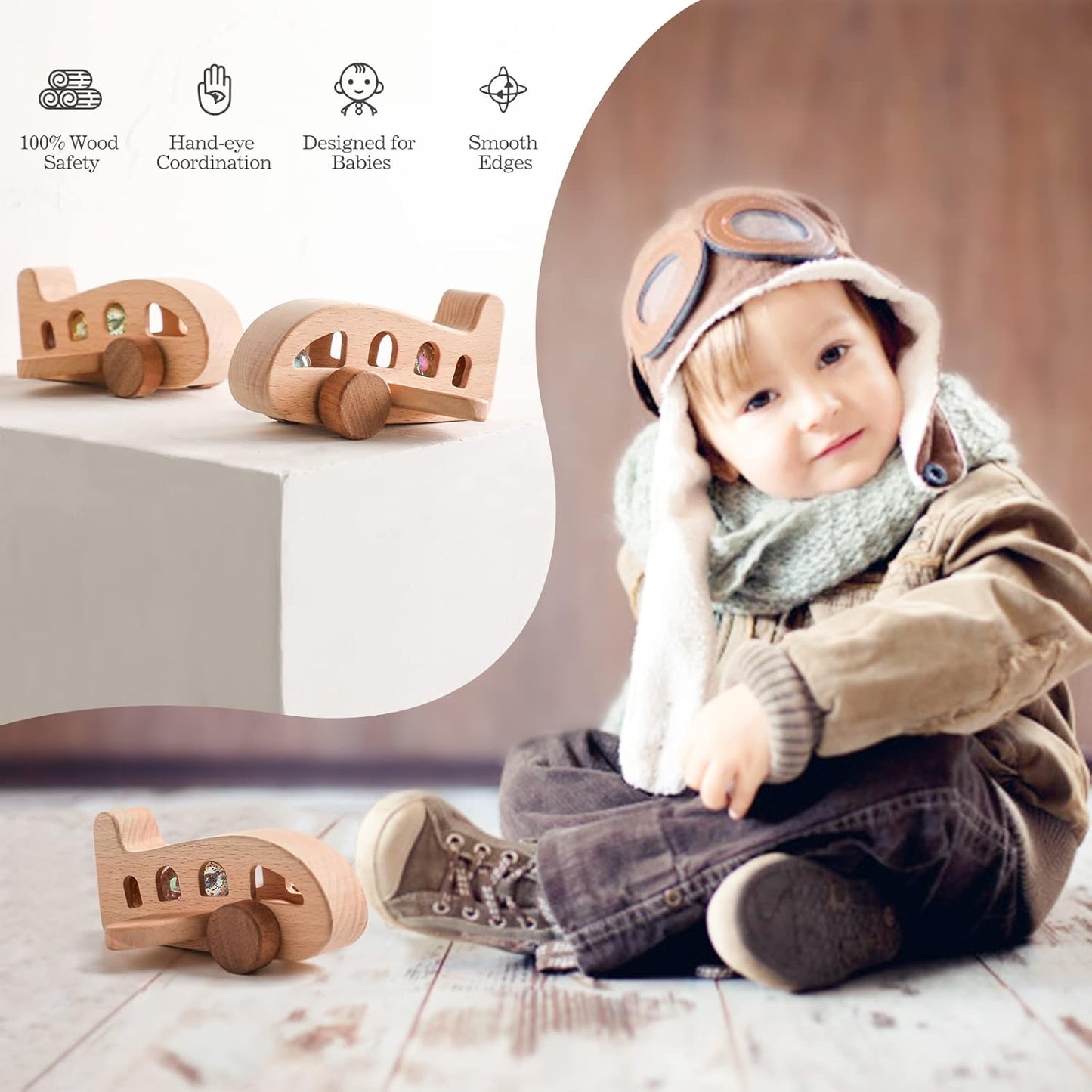 Child wearing a pilot hat with wooden toy airplanes on a light background