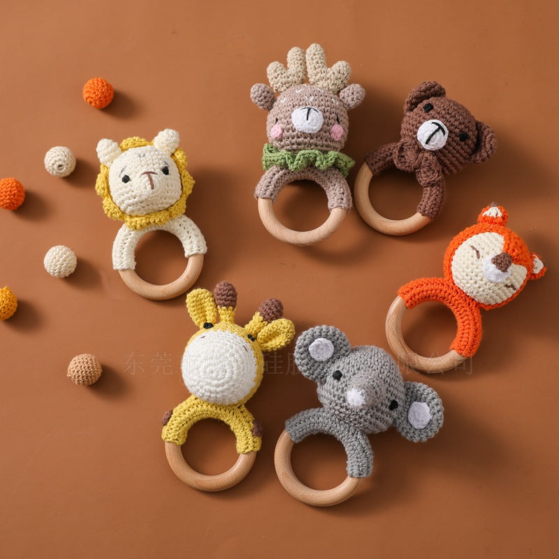 Set of animal-themed teething rings on a brown background