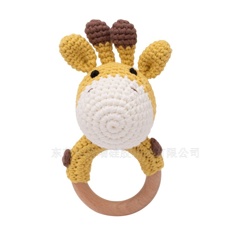 Crocheted giraffe rattle toy on a white background