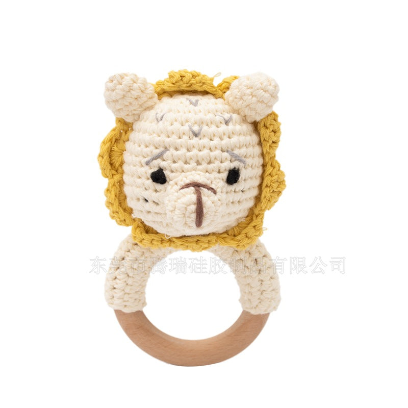 Crocheted lion baby rattle toy on a white background