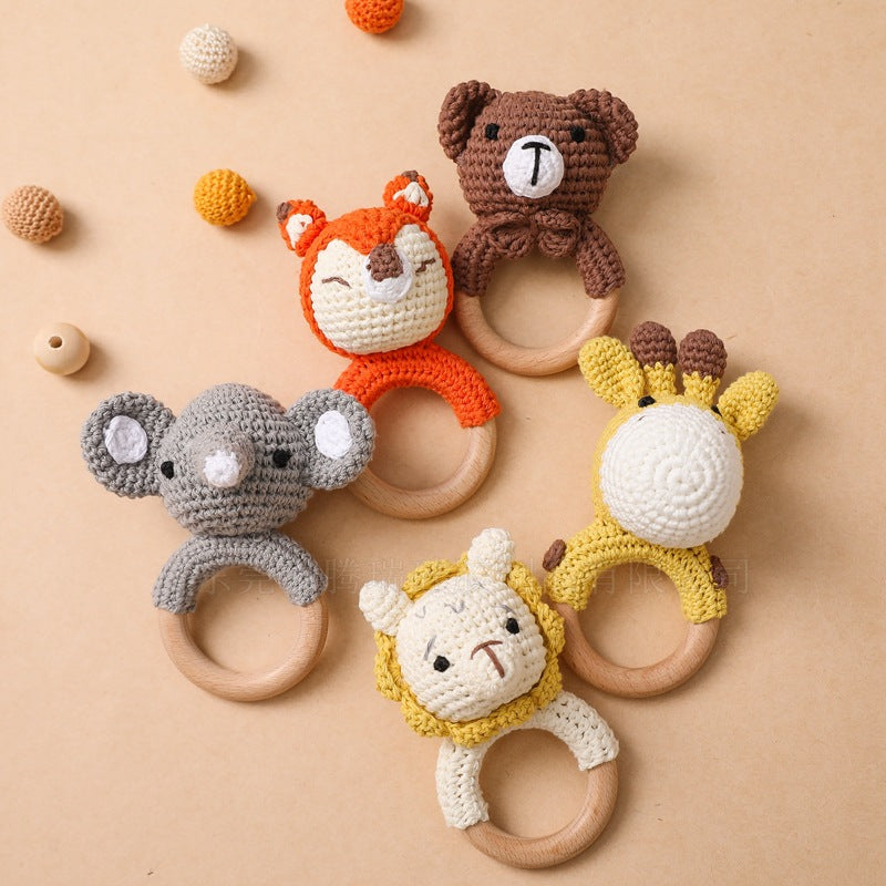 Set of animal-themed teething rings on a beige background