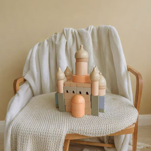 Wooden toy castle on a chair with a soft blanket