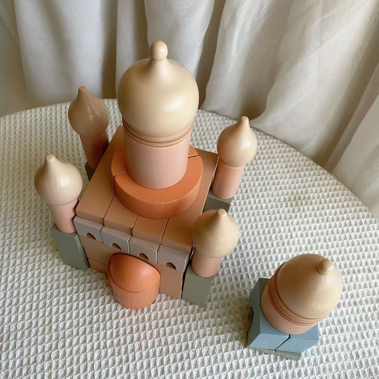 Toy castle made of interlocking bricks on a textured surface