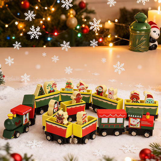 Wooden toy train set with Christmas-themed cars on a decorative surface with snowflakes and a Christmas tree in the background.