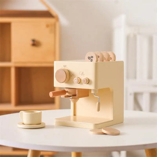 Wooden toy espresso machine on a white surface with a blurred wooden shelf in the background