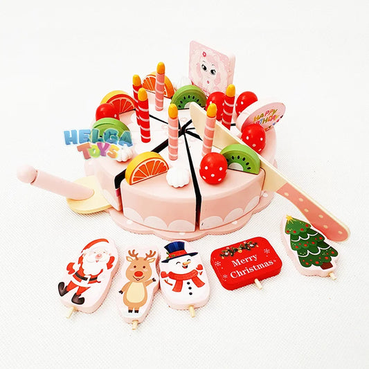 Toy cake set with Christmas-themed candles on a white background