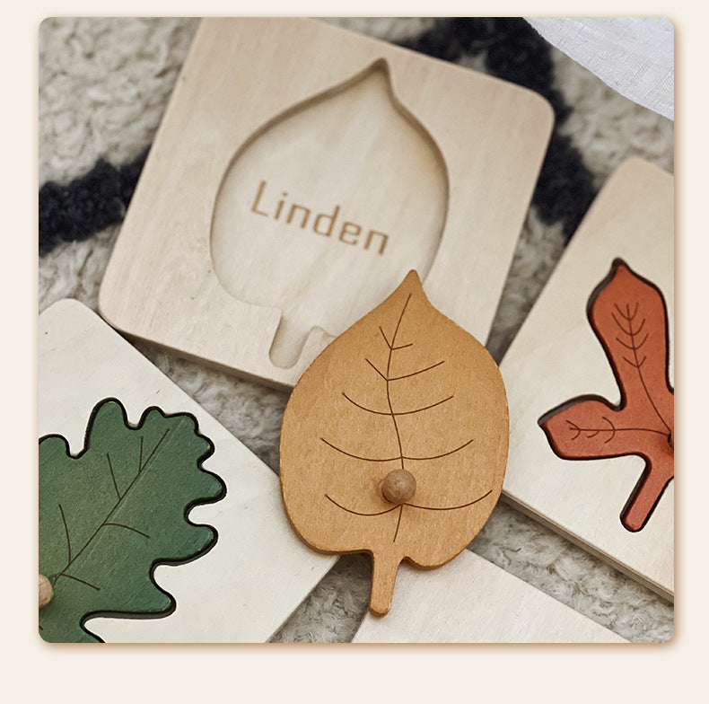 Wooden leaf-shaped toys with 'Linden' branding on a textured surface