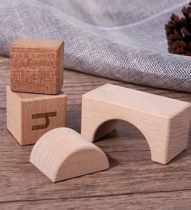 Set of wooden building blocks on a wooden surface with a textured fabric background