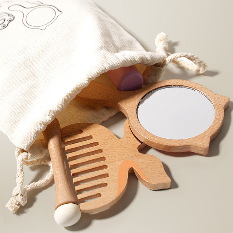 Wooden comb and mirror set with a white drawstring bag on a light background