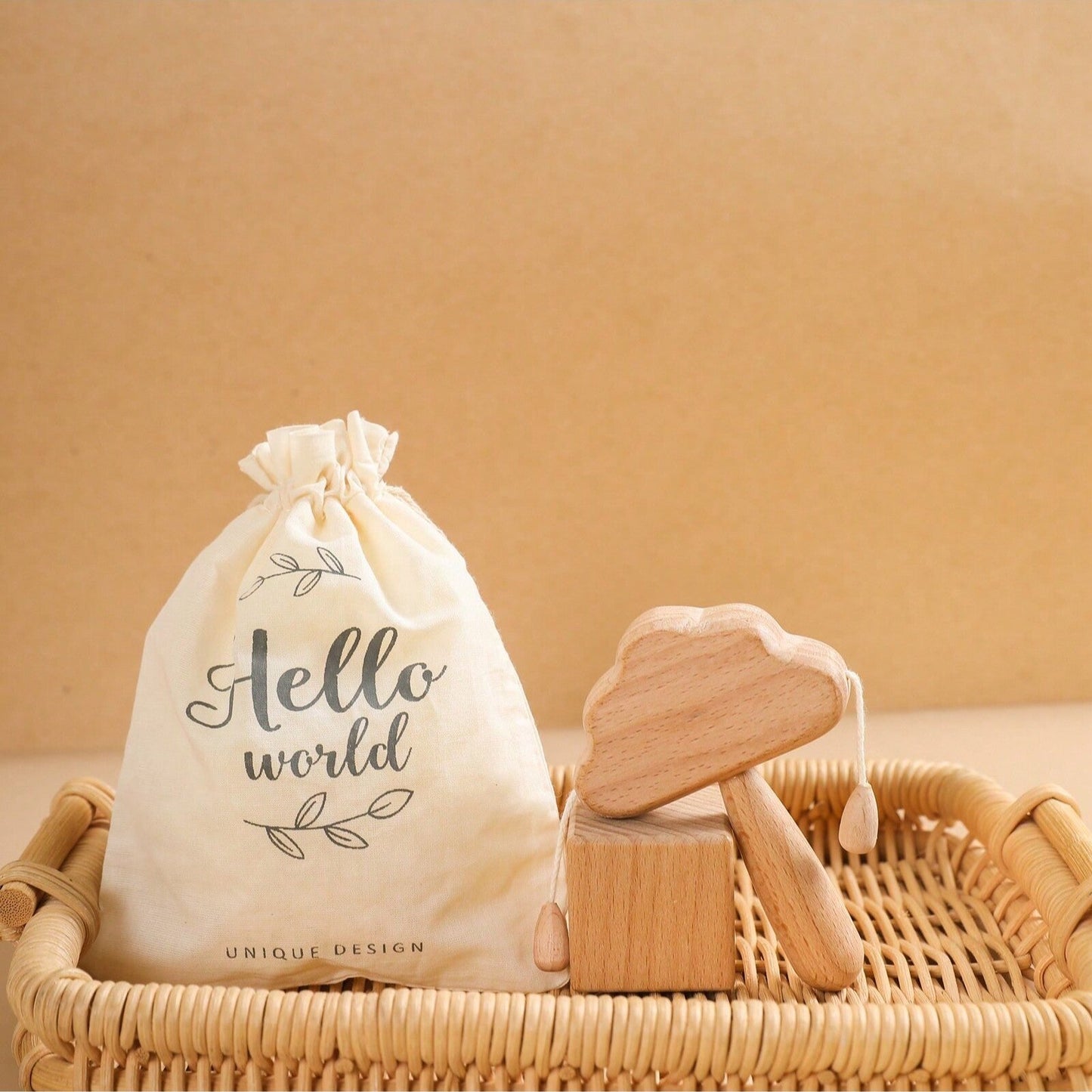 White drawstring bag with 'Hello world' text on a woven basket against a beige background