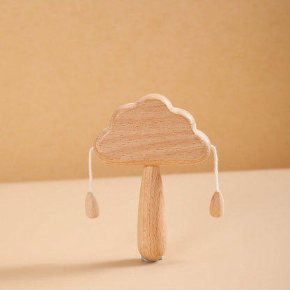 Wooden cloud-shaped rattle on a beige background