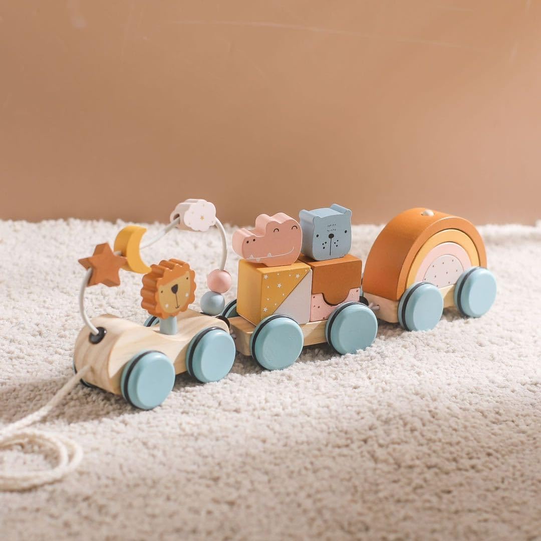 Wooden toy train with animal figures on a soft surface
