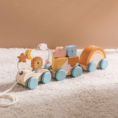 Wooden toy train with animal figures on a soft surface