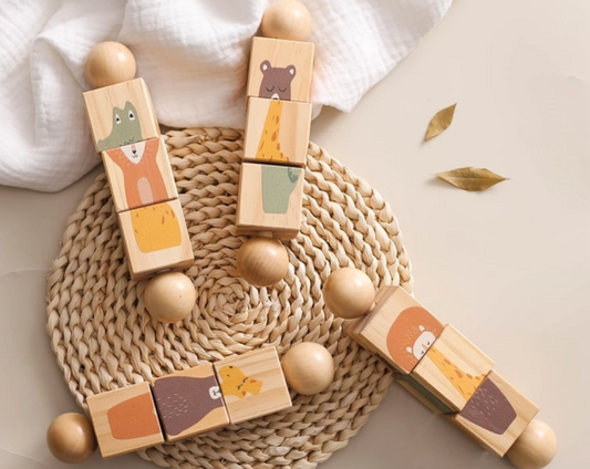 Wooden blocks with animal designs on a woven mat