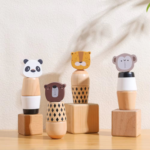 Set of wooden toys with animal faces on a light background