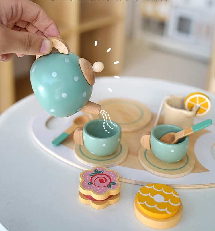 Wooden tea set with teapot, cups, and cookies on a white surface.