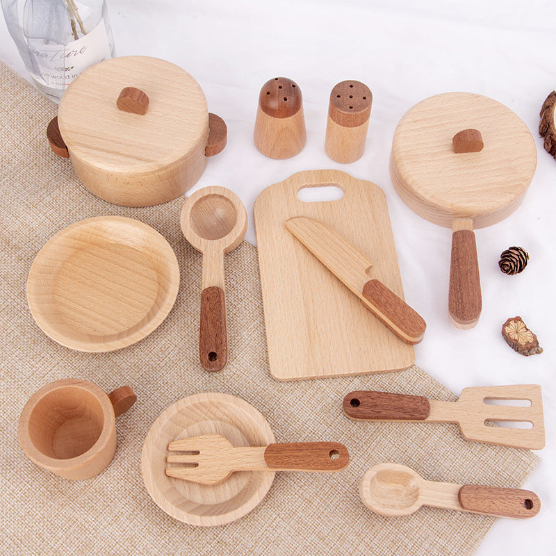 Set of wooden kitchen utensils including bowls, spoons, and cutting board on a textured surface.