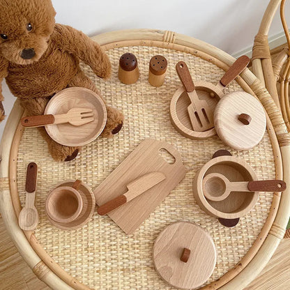 Wooden toy kitchen set with teddy bear on a woven tray