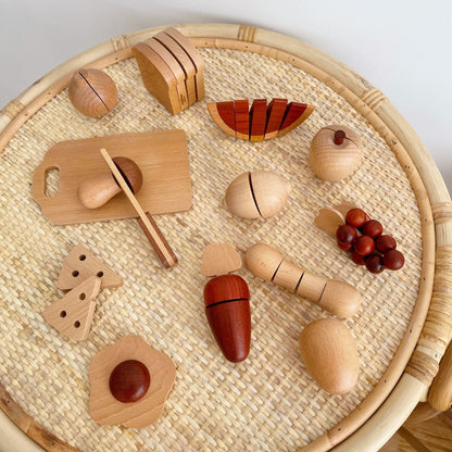 Wooden toy fruits and vegetables on a woven mat
