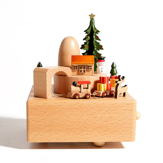 Wooden toy set with a Christmas scene including a tree, house, and animals on a white background.