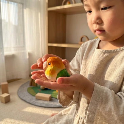 Toddler holding handpainted wooden bird toy, natural geometric lovebird figurine safe for kids, Montessori wooden animal toy for imaginative play