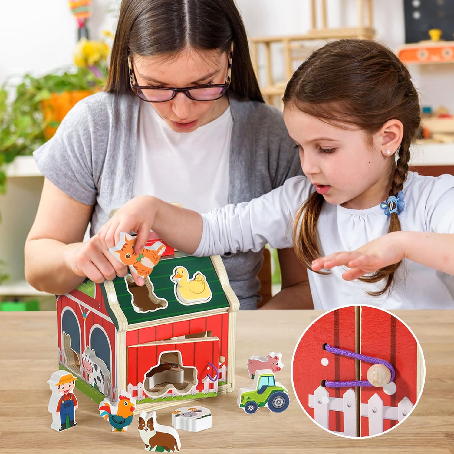 Woman and young girl playing with a wooden farm toy set.