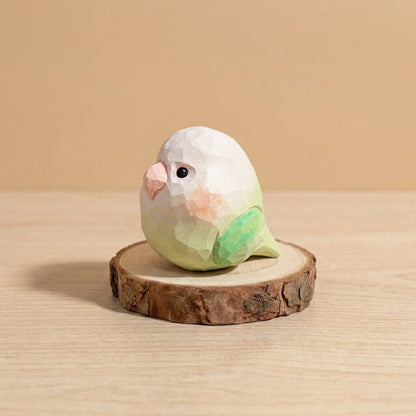 Front view green and white wooden lovebird toy with orange cheek detail, handpainted low-poly bird figurine sustainable natural wood craft toy for toddlers imaginative play